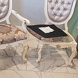 The white coat delivery person didn't bother to attach the one seat. He also on the two chairs that are actually pearl white enough put a yellow leg in the front of each of them. That looks real lovely. Not!