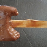 Large, sharp splinter on the stick of fudge bar.