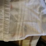 Buttons fell off first wear (sewn on by a single stitch with a bundle of threads) and synthetic fabric VERY see through as you can see the box writing underneath the shirt here. Blouse was "s" and less than a size zero.