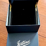 A rather weak magnet meant to keep jewelry from "roaming" is attached behind black velour covered liftup panel. Sample jewelry only remained stationary momentarily before sliding out of place.