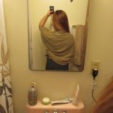 The length of the sweater worn by the model on the site goes down to her thighs. Pictured here, the sweater barely sits on my waist. You can compare this picture with the next picture of the model.