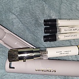 The larger vial is the month's subscription, with a case. I've learned that alot of longtime customers hate the new design of the cases, they're magnetic. To the right are the sampler sizes.