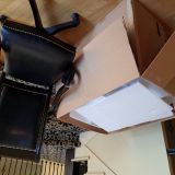 Photo of undamaged box and chair with two broken arms