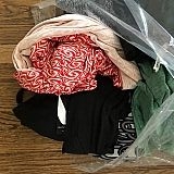 And here are some of my balled up clothing that were spilling out of the box. This is literally how they returned my things. Note the hang tags on everything that I never approved...