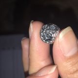Look inside of the charm, all opaque and charcoalish