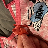 Bow not even completely sewn on