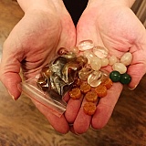My girlfriend holding carved carnelian beads, rose quartz nugget beads, green aventurine rounds, clear quartz nugget beads and carnelian nugget beads in a baggy- all bought from Dollar Bead. The photo does none of them any justice, sorry! I tried.